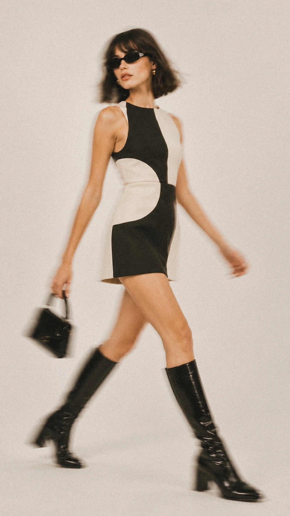 Graphic black-and-cream dress captured in motion.
